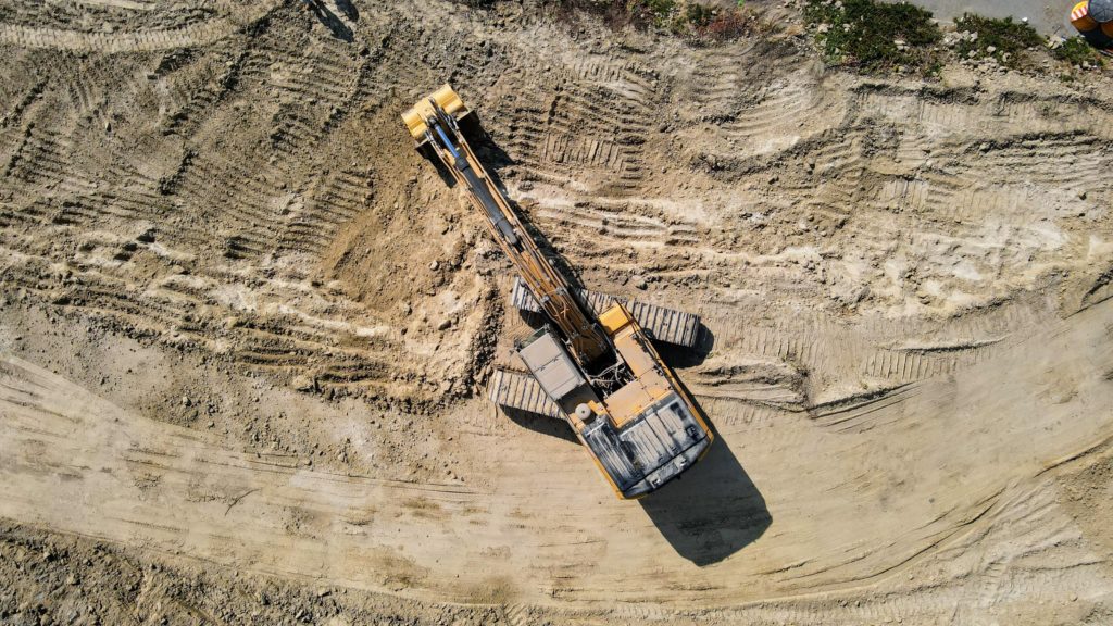Aerial view of excavator working on newly eroded land