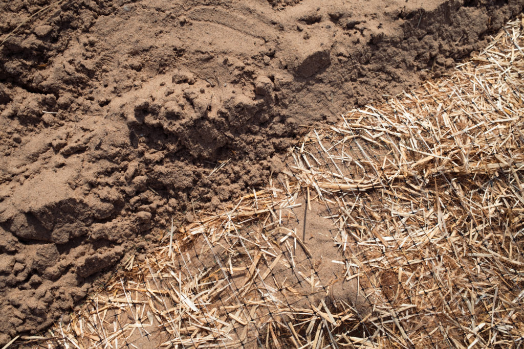 Closeup of comparing sand and straw mat
