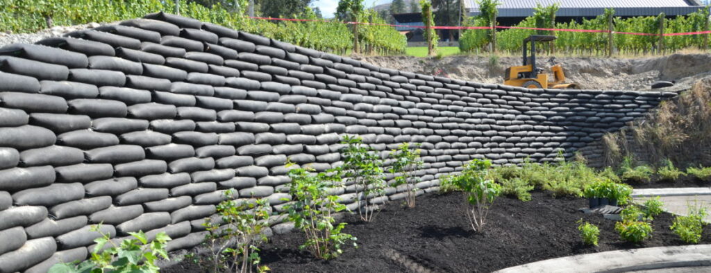 A freshly installed Flex MSE retaining wall aids commercial landscaping by preventing erosion and beautifying the area.