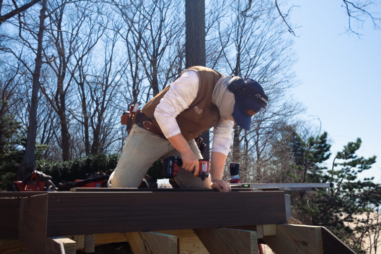A Lakeshore Customs contractor works on building a custom deck during the winter.