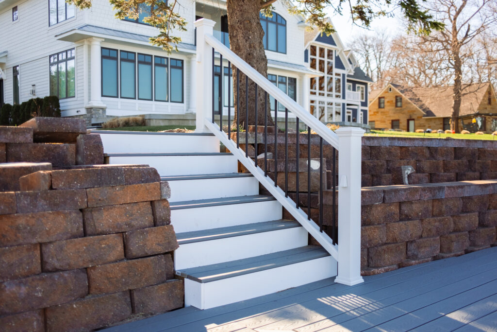 Gray composite decking and stairs with custom railings.