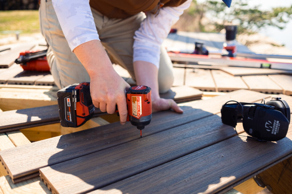 A professional deck builder with Lakeshore Customs resurfaces a deck with composite materials.